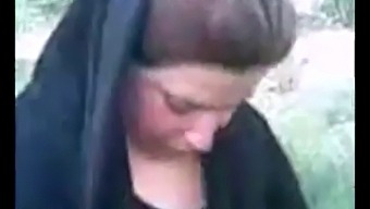 Hijab-Wearing Arab Woman Indulges In Outdoor Pleasure
